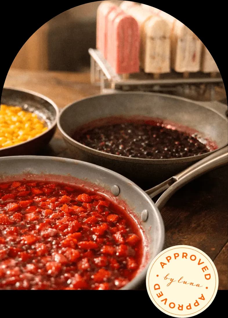 Pots of fresh fruit compote being prepared in the LA PALETA kitchen, with the Approved by Luna stamp